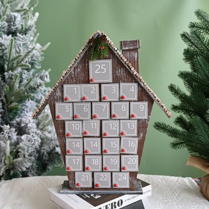 Detail of wooden 24-day advent calendar house with gray drawers and red knobs