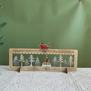 Detail of wooden Christmas advent calendar featuring a sliding Santa and forest scene