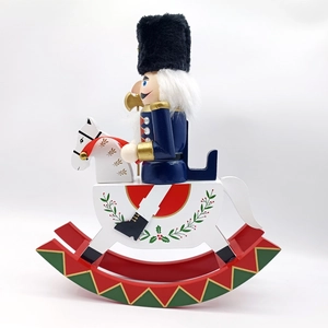 Close-up of traditional nutcracker soldier on rocking horse with golden axe and hat