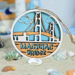 Macro detail of multi-layer wooden Mackinac Bridge wall decor with beach shells