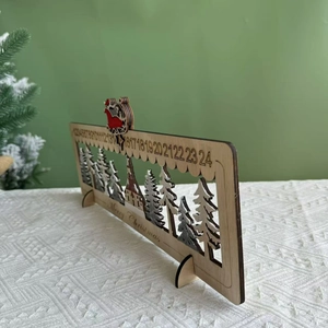 Detail of wooden advent calendar showing laser-cut forest layers and Santa's sleigh