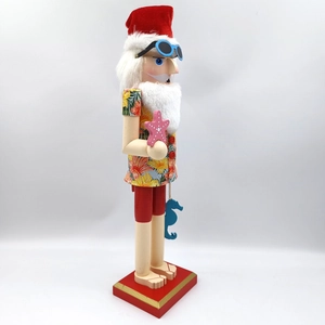 Detail of wooden tropical Nutcracker in Hawaiian shirt and sunglasses with pink starfish