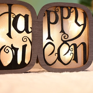 Close-up of Halloween wooden BOO letter light with warm LED and hollow engraving