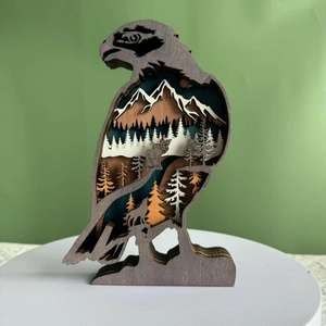 Detail of multi-layer wood carving eagle featuring mountains and forest landscape