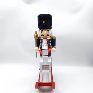 Close-up of wooden nutcracker soldier on rocking horse with golden halberd detail
