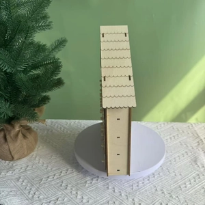 Detailed close-up of a white wooden house advent calendar with festive holiday decor