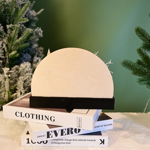 Detail of DIY semi-circular wooden plaque with a black base for festive Halloween crafts