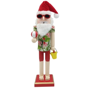 Detail of wooden Hawaiian Santa nutcracker with beach ball, bucket and tropical floral shirt