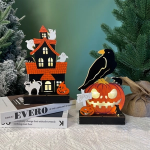 Detail of wooden Halloween LED decorations featuring a haunted house and crow on a pumpkin