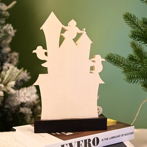 Macro detail of laser-cut wooden Halloween castle silhouette on a black base