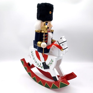 Close-up of wooden nutcracker soldier on a rocking horse with hand-painted details