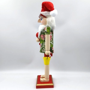 Detail of tropical Santa nutcracker wearing Hawaiian shirt and sunglasses on red base