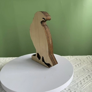 Detailed view of multilayer laser-cut wooden eagle ornament with 3D stacked structure