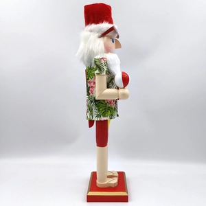 Detail of wooden nutcracker in Hawaiian shirt holding a beach ball for party decor