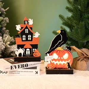 Detail of wooden Halloween LED ornament featuring a haunted house, crow and glowing BOO sign