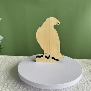 Detail view of laser-cut layered wooden eagle sculpture showing natural wood grain texture