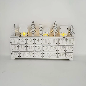 Detail of wooden 24-day advent calendar with LED lighted houses and numbered drawers
