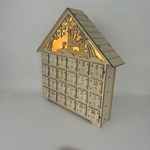 Illuminated wooden house advent calendar with 24 drawers and laser-cut festive scene