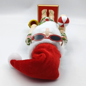 Detail of beach Santa nutcracker with floral shirt, sunglasses and tropical accessories