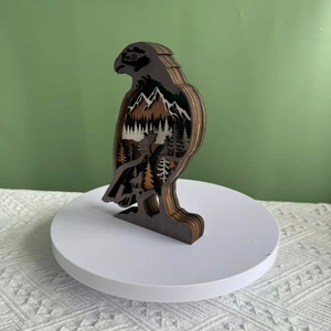 Detailed view of layered 3D wooden eagle sculpture with laser-cut forest and wolf scene