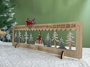 Close-up of wooden advent calendar with laser-cut trees and sliding Santa sleigh