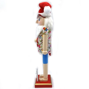 Side view of a Hawaiian Santa nutcracker with a floral shirt and sunglasses on a red base
