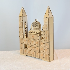 Detail of wooden Ramadan countdown calendar with 30 numbered drawers and mosque design