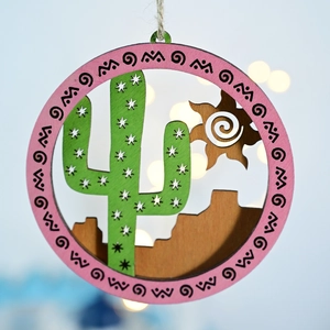 Detail of wooden coastal plaque featuring laser-cut cactus and mountain designs
