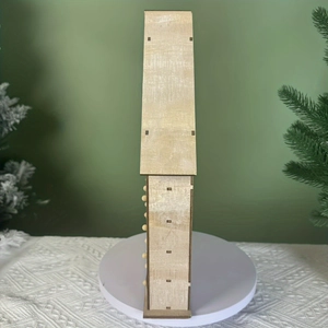 Vue latérale détaillée du calendrier de l'Avent en bois en forme de maison avec tiroirs