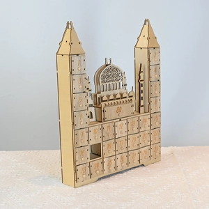 Detail of laser-cut wooden mosque countdown calendar with thirty numbered gift drawers