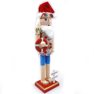 Detail of Hawaiian Nutcracker in summer outfit with sunglasses and Christmas in July sign