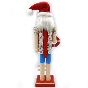 Macro shot of tropical nutcracker ornament wearing flower shirt and holding lifebuoy