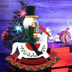 Detail of wooden nutcracker soldier on white rocking horse with holly leaf patterns