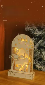Detail of warm LED moon lamp with mosque silhouette and intricate hollow wood carvings