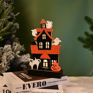 Detail of wooden Halloween LED ornament featuring spooky castle and ghosts on books