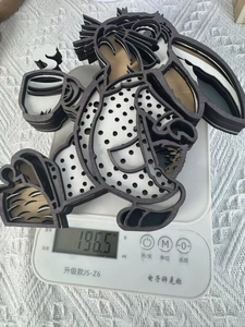 3D layered wooden rabbit decoration in polka dot pajamas shown weighing 196.5g on a scale
