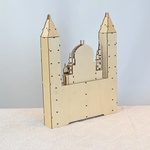 Detail of laser-cut wooden Eid countdown calendar with intricate Islamic architecture design
