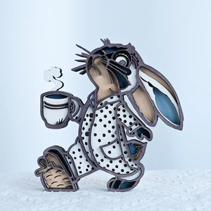 Detail of 3D layered wood rabbit ornament with laser-cut coffee element and polka dot pattern