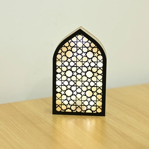 Macro shot of warm LED glow through Islamic geometric star patterns on a wooden arch