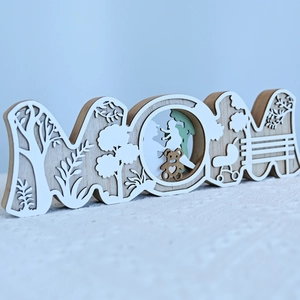 Détail du panneau MOM en bois multicouche découpé au laser avec silhouette familiale