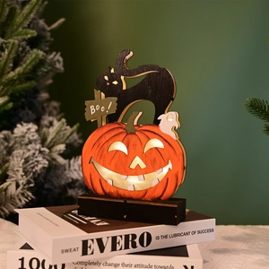 Detail of wooden Halloween LED ornament with pumpkin, black cat and Boo ghost on books