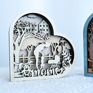 Detailed macro view of laser-cut multi-layer wooden heart decor with mom and stroller scene