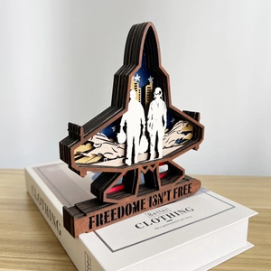 Detailed layered wood carving of a fighter jet with Freedom Is Not Free engraving