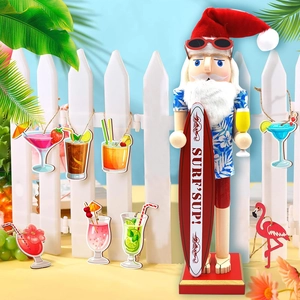 Hawaiian Nutcracker surfer with surfboard and tropical ornaments on white fence