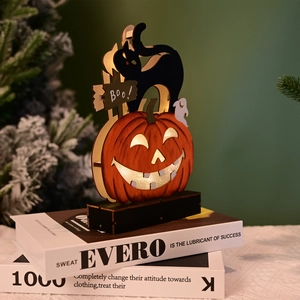 Close-up of LED wooden Halloween ornament featuring a ghost, black cat, and pumpkin carvings