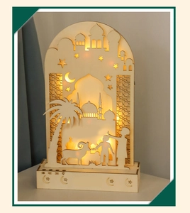 Detail of wooden LED moon lamp with mosque silhouette and media control buttons on base