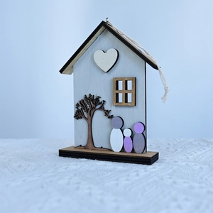 Detail of wooden house-shaped Mother's Day ornament with heart and family silhouettes