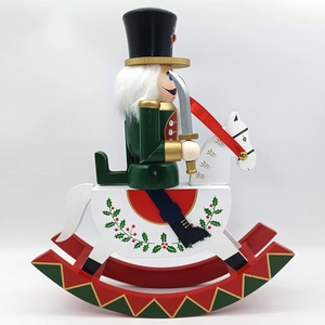 Detail of wooden nutcracker soldier on rocking horse with festive painted holly patterns