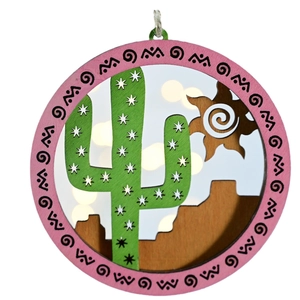 Circular layered wooden ornament featuring a laser-cut desert scene and cactus motif