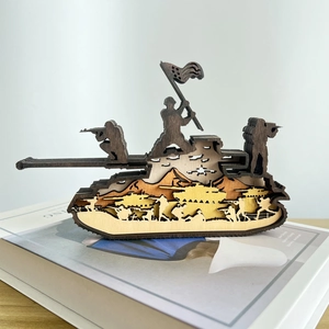 Detail of layered wood carving showing tank silhouette and soldiers in military scene
